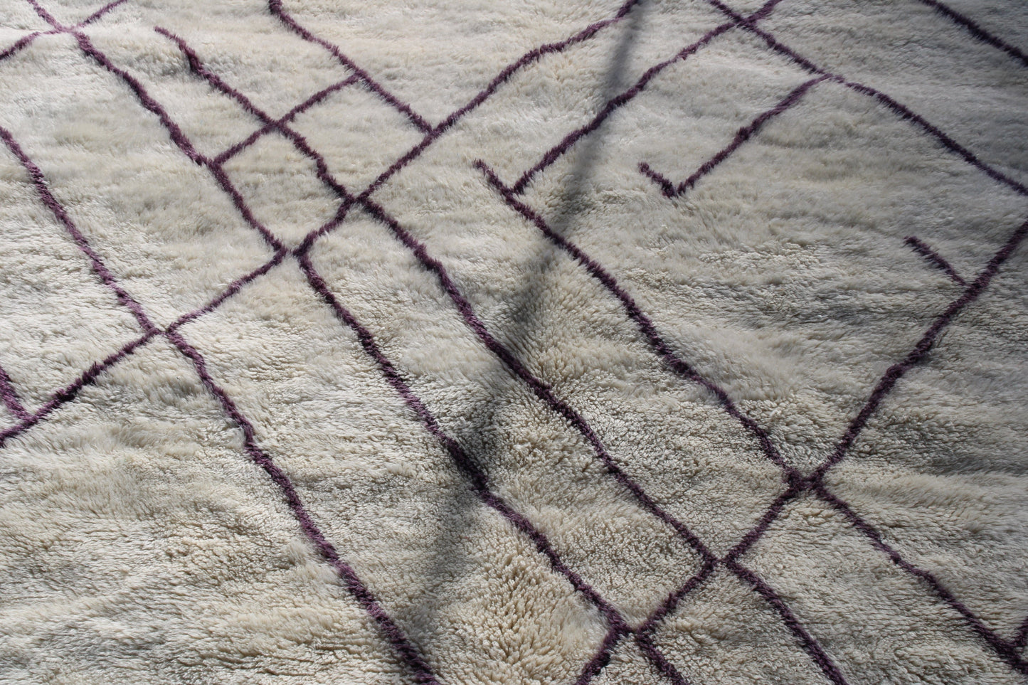 Beni Ourain rugs originate from the Atlas Mountains of Morocco and are characterized by their distinctive, neutral-toned, and geometric designs. These handwoven rugs often feature a plush pile and are made by the Berber tribes, size is 310x210 cm