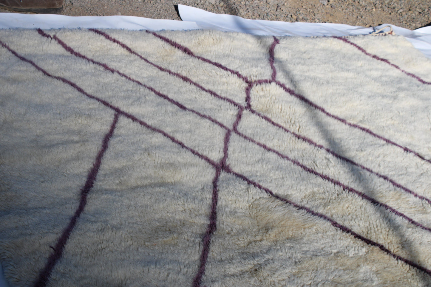 Beni Ourain rugs originate from the Atlas Mountains of Morocco and are characterized by their distinctive, neutral-toned, and geometric designs. These handwoven rugs often feature a plush pile and are made by the Berber tribes, size is 310x210 cm