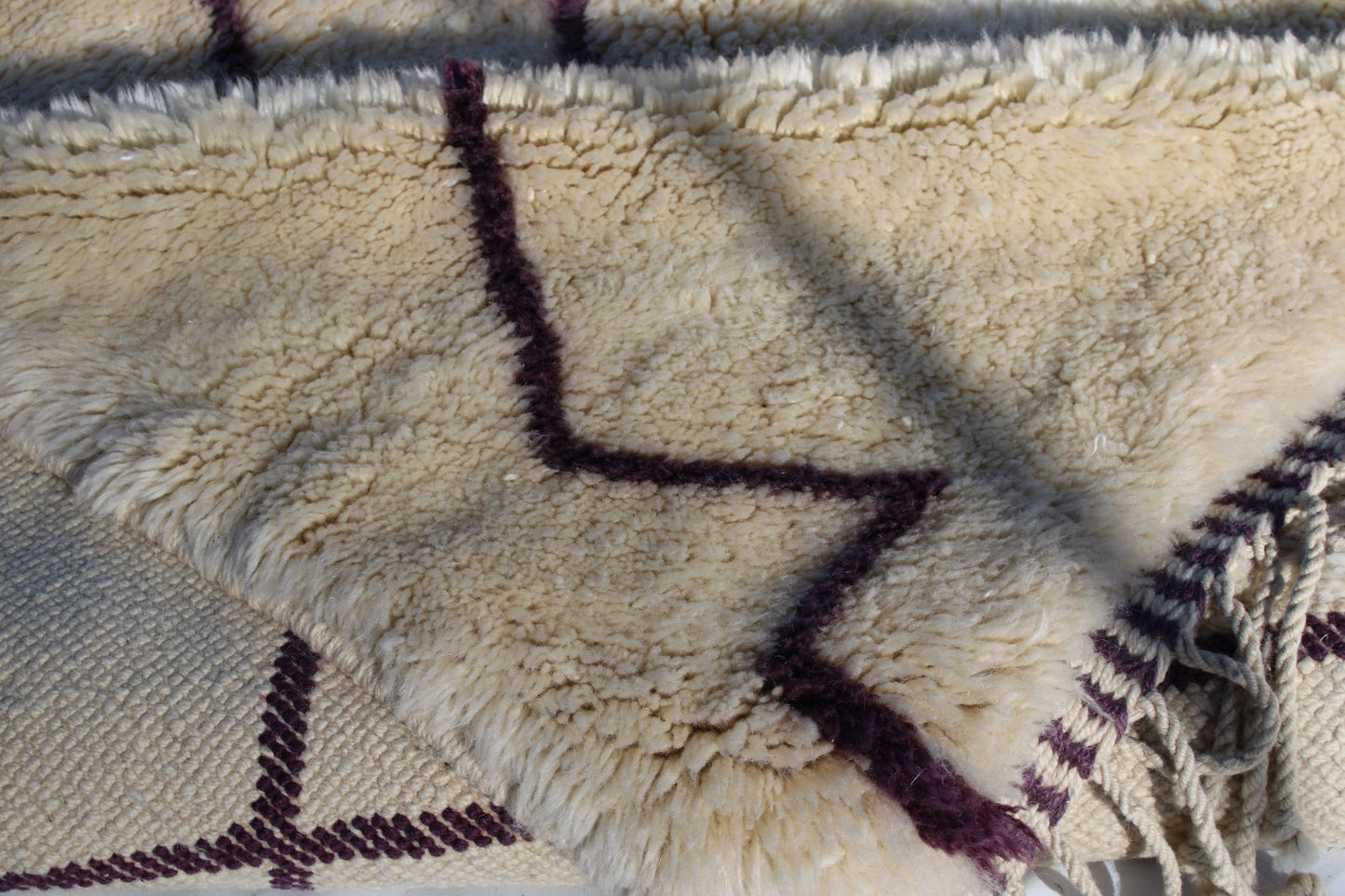 Beni Ourain rugs originate from the Atlas Mountains of Morocco and are characterized by their distinctive, neutral-toned, and geometric designs. These handwoven rugs often feature a plush pile and are made by the Berber tribes, size is 310x210 cm