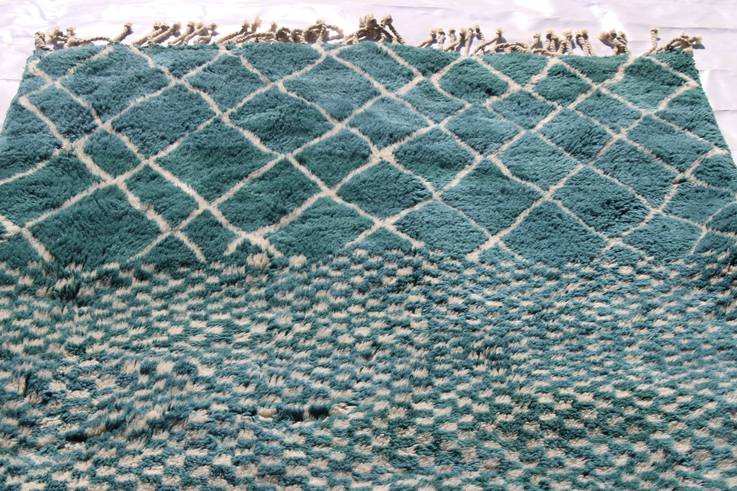 Beni Ourain rugs originate from the Atlas Mountains of Morocco and are characterized by their distinctive, neutral-toned, and geometric designs. These handwoven rugs often feature a plush pile and are made by the Berber tribes, size is 250x150cm