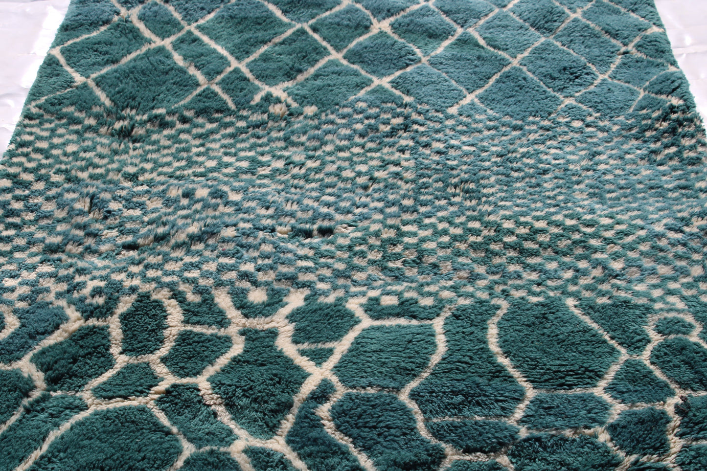 Beni Ourain rugs originate from the Atlas Mountains of Morocco and are characterized by their distinctive, neutral-toned, and geometric designs. These handwoven rugs often feature a plush pile and are made by the Berber tribes, size is 250x150cm