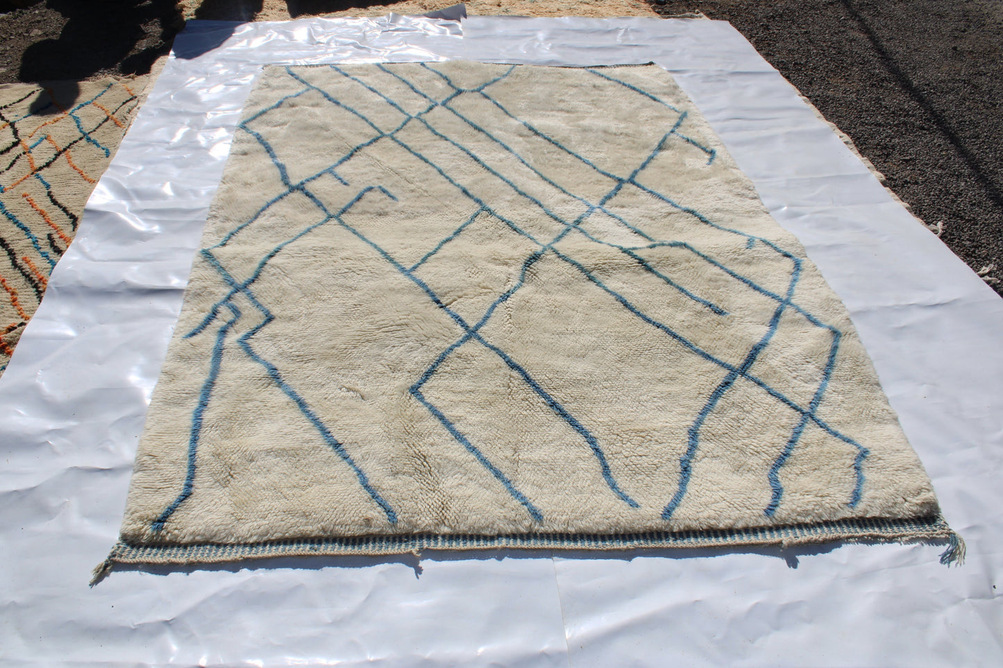 Beni Ourain rugs originate from the Atlas Mountains of Morocco and are characterized by their distinctive, neutral-toned, and geometric designs. These handwoven rugs often feature a plush pile and are made by the Berber tribes, size is 270x192 cm