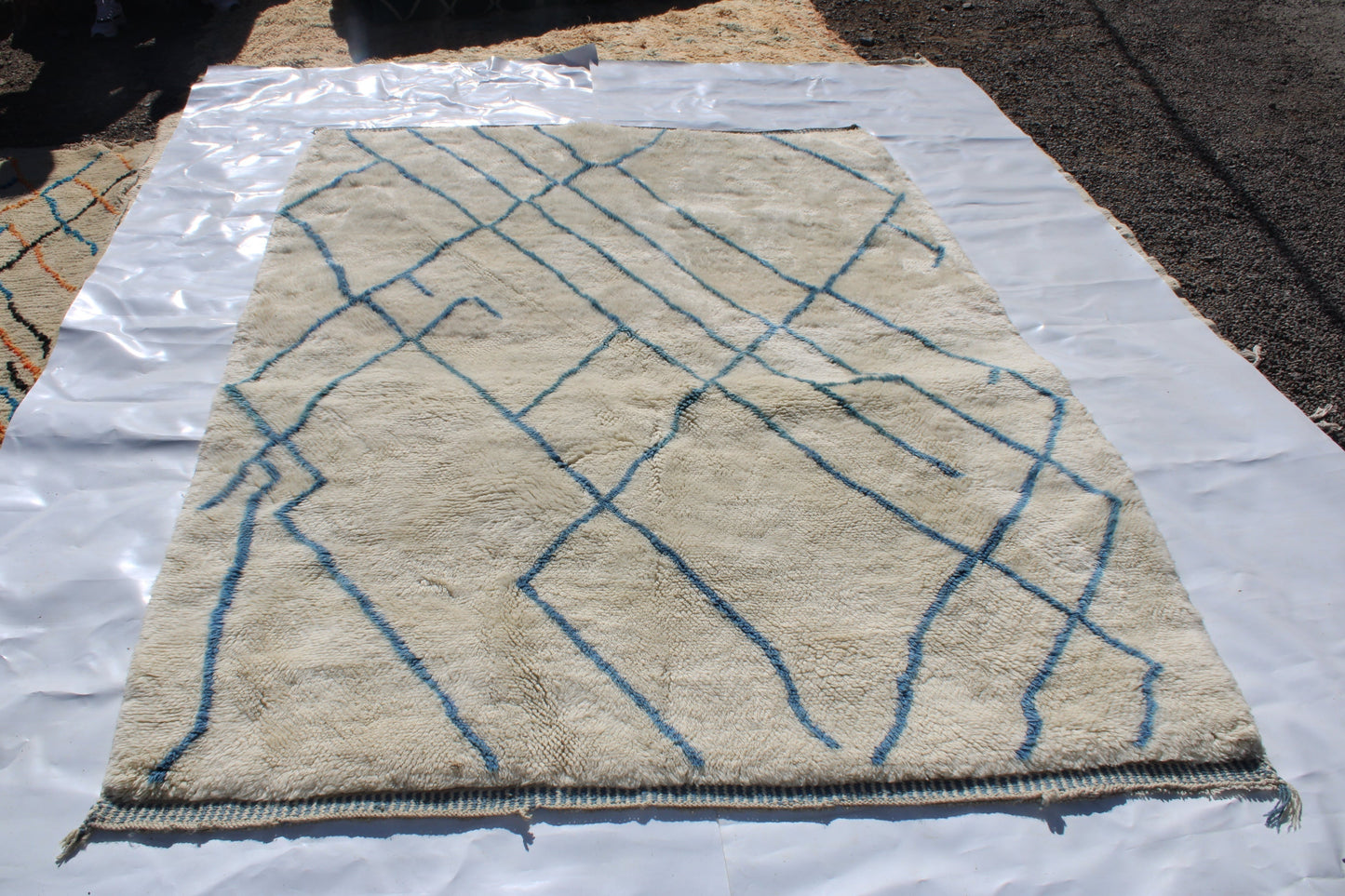 Beni Ourain rugs originate from the Atlas Mountains of Morocco and are characterized by their distinctive, neutral-toned, and geometric designs. These handwoven rugs often feature a plush pile and are made by the Berber tribes, size is 270x192 cm