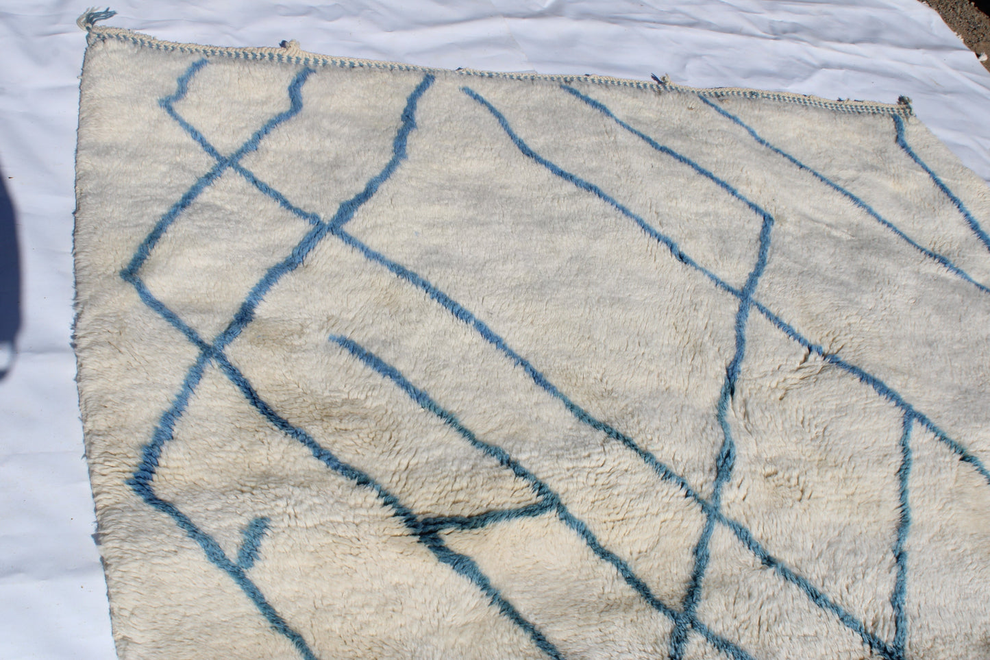 Beni Ourain rugs originate from the Atlas Mountains of Morocco and are characterized by their distinctive, neutral-toned, and geometric designs. These handwoven rugs often feature a plush pile and are made by the Berber tribes, size is 270x192 cm