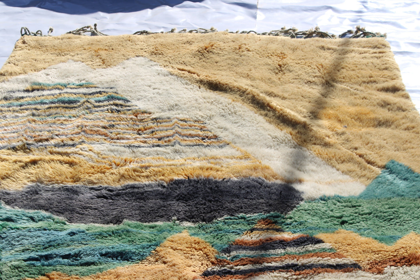 Beni Ourain rugs originate from the Atlas Mountains of Morocco and are characterized by their distinctive, neutral-toned, and geometric designs. These handwoven rugs often feature a plush pile and are made by the Berber tribes, size is 280x177 cm