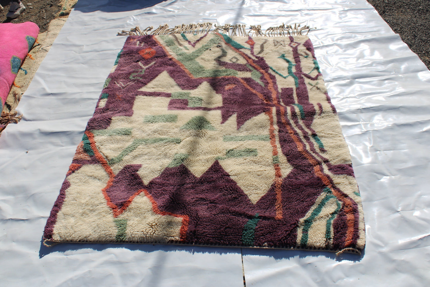 Beni Ourain rugs originate from the Atlas Mountains of Morocco and are characterized by their distinctive, neutral-toned, and geometric designs. These handwoven rugs often feature a plush pile and are made by the Berber tribes, size is 224x160 cm