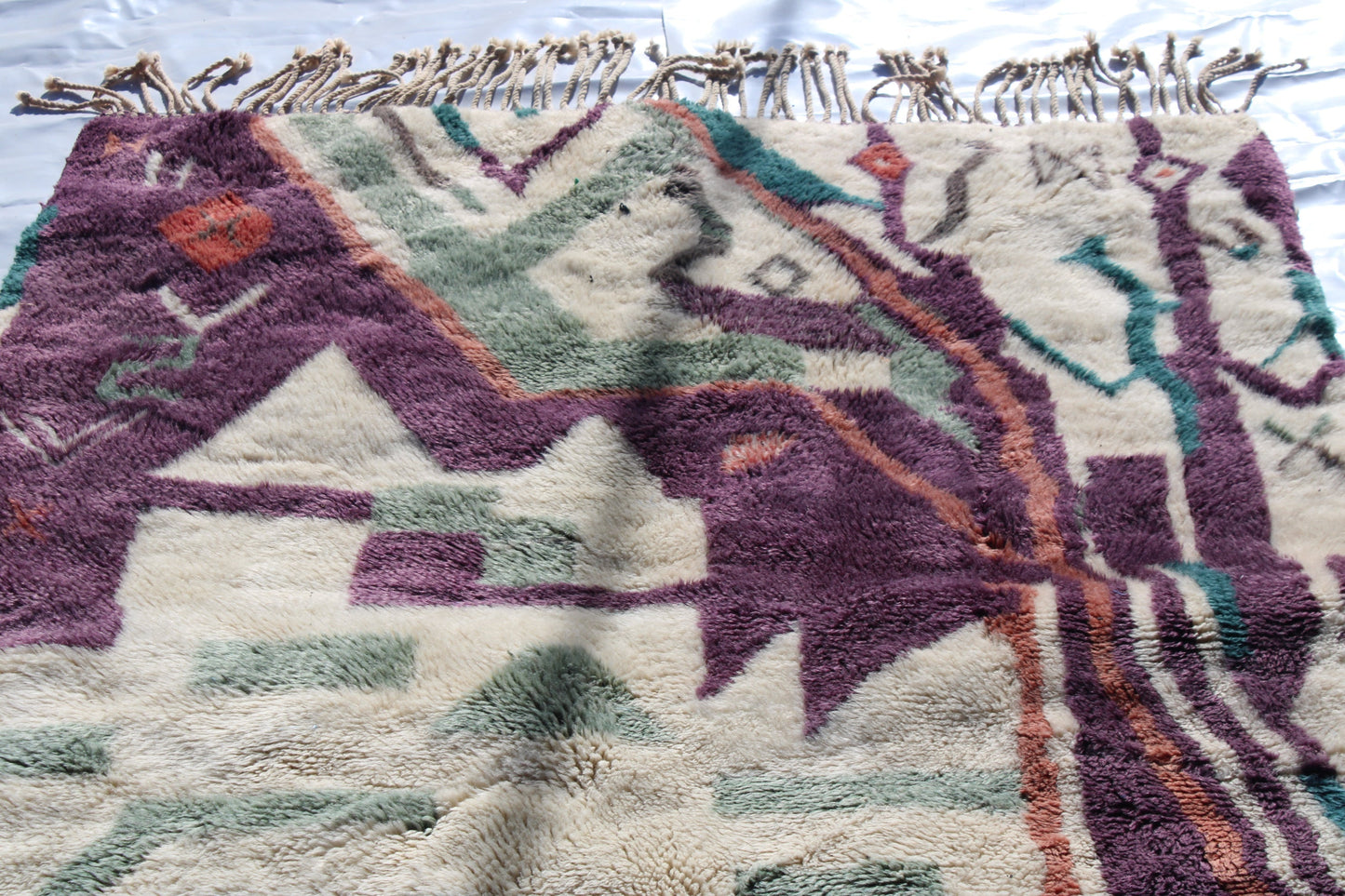 Beni Ourain rugs originate from the Atlas Mountains of Morocco and are characterized by their distinctive, neutral-toned, and geometric designs. These handwoven rugs often feature a plush pile and are made by the Berber tribes, size is 224x160 cm