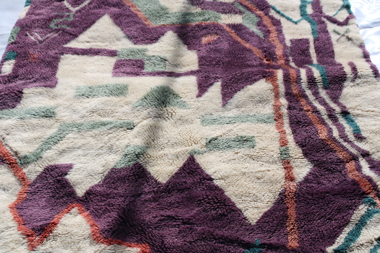 Beni Ourain rugs originate from the Atlas Mountains of Morocco and are characterized by their distinctive, neutral-toned, and geometric designs. These handwoven rugs often feature a plush pile and are made by the Berber tribes, size is 224x160 cm