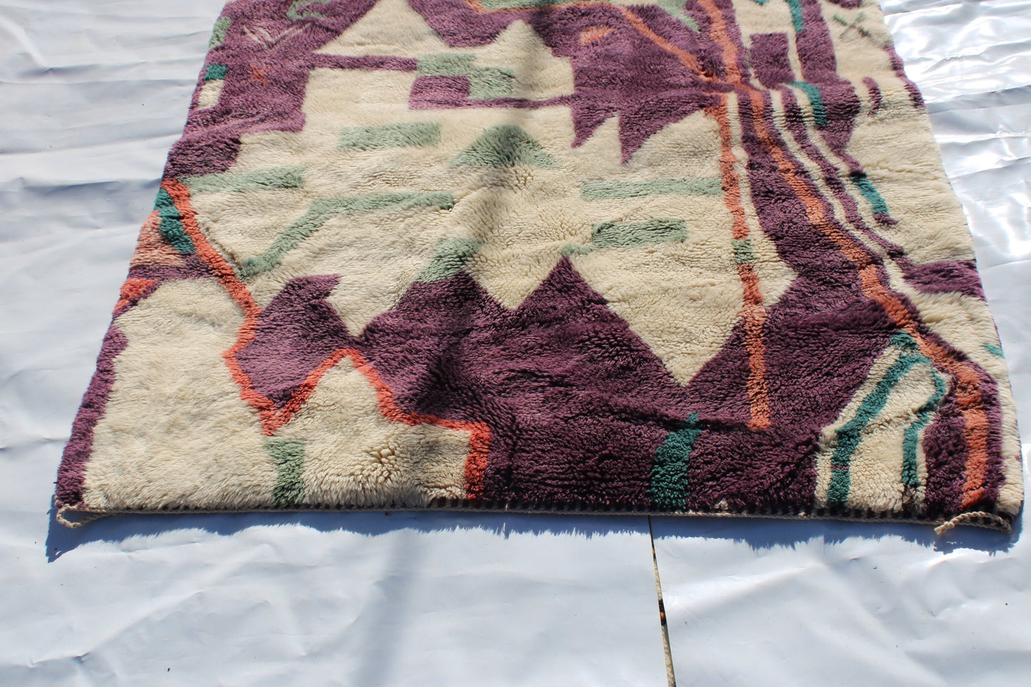 Beni Ourain rugs originate from the Atlas Mountains of Morocco and are characterized by their distinctive, neutral-toned, and geometric designs. These handwoven rugs often feature a plush pile and are made by the Berber tribes, size is 224x160 cm