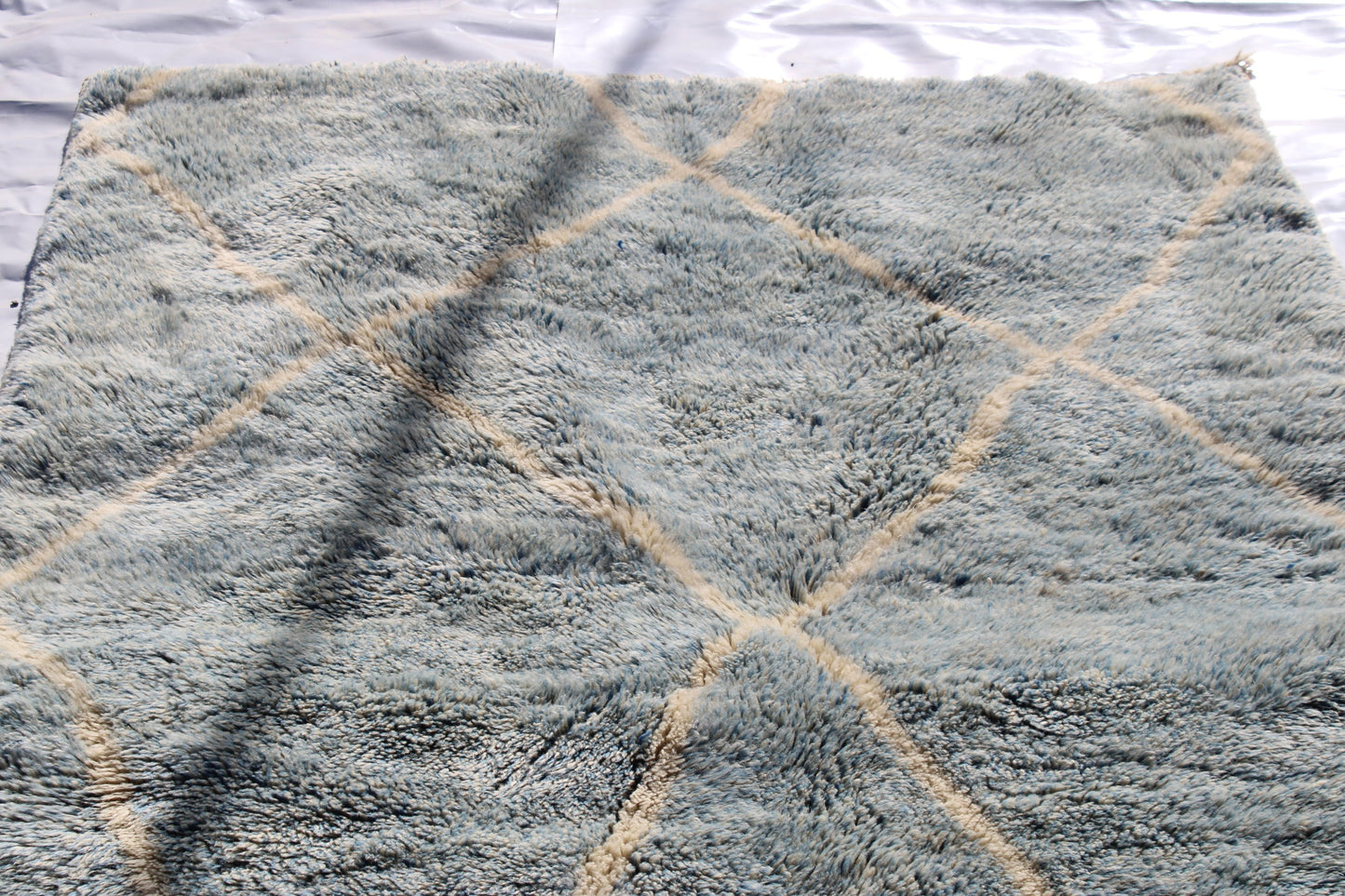 Beni Ourain rugs originate from the Atlas Mountains of Morocco and are characterized by their distinctive, neutral-toned, and geometric designs. These handwoven rugs often feature a plush pile and are made by the Berber tribes, size is 260x160 cm