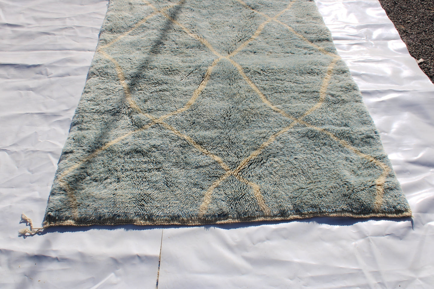 Beni Ourain rugs originate from the Atlas Mountains of Morocco and are characterized by their distinctive, neutral-toned, and geometric designs. These handwoven rugs often feature a plush pile and are made by the Berber tribes, size is 260x160 cm