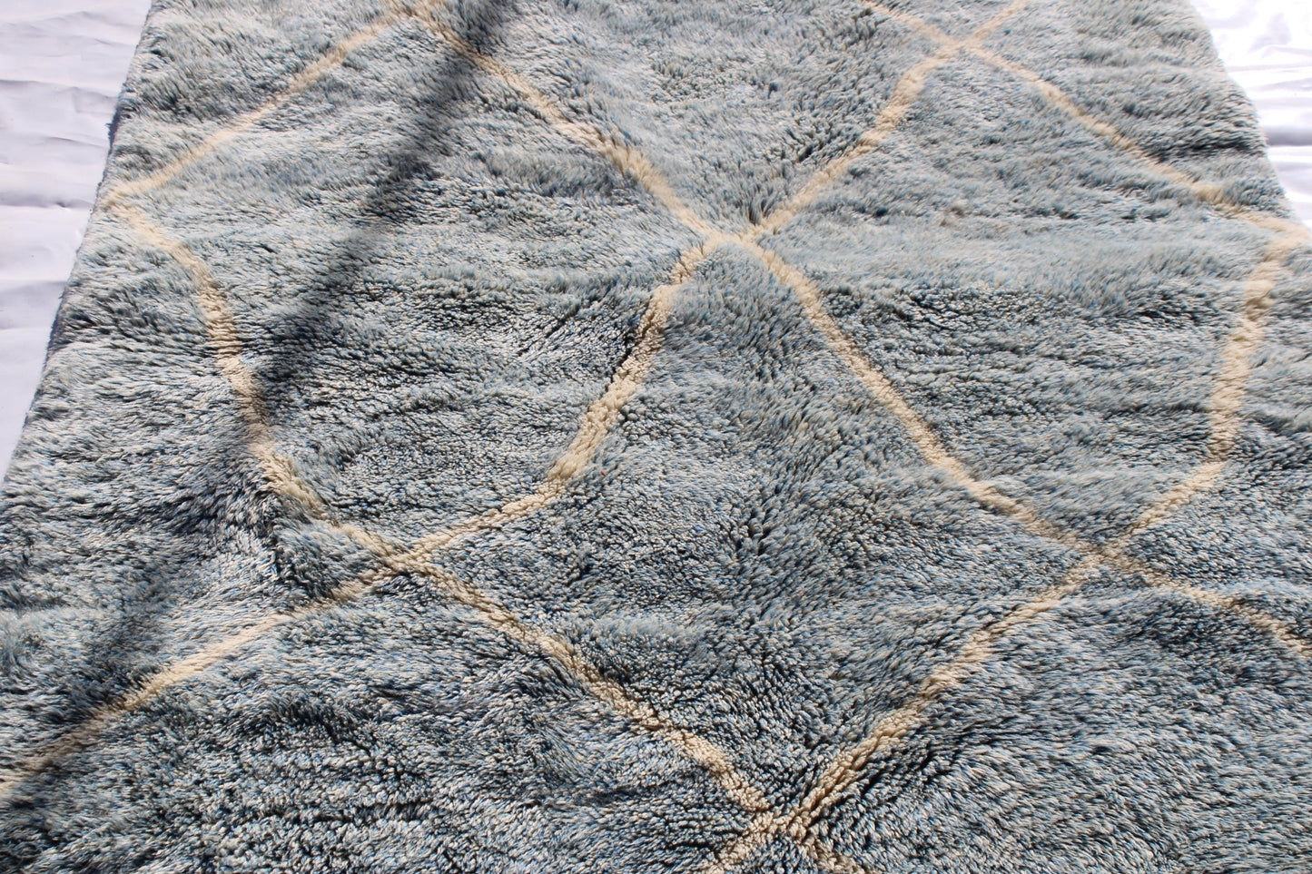 Beni Ourain rugs originate from the Atlas Mountains of Morocco and are characterized by their distinctive, neutral-toned, and geometric designs. These handwoven rugs often feature a plush pile and are made by the Berber tribes, size is 260x160 cm