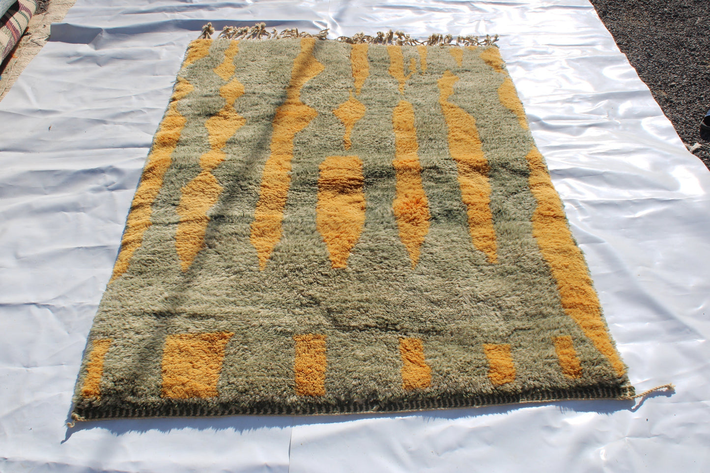Beni Ourain rugs originate from the Atlas Mountains of Morocco and are characterized by their distinctive, neutral-toned, and geometric designs. These handwoven rugs often feature a plush pile and are made by the Berber tribes, size is 230x155 cm