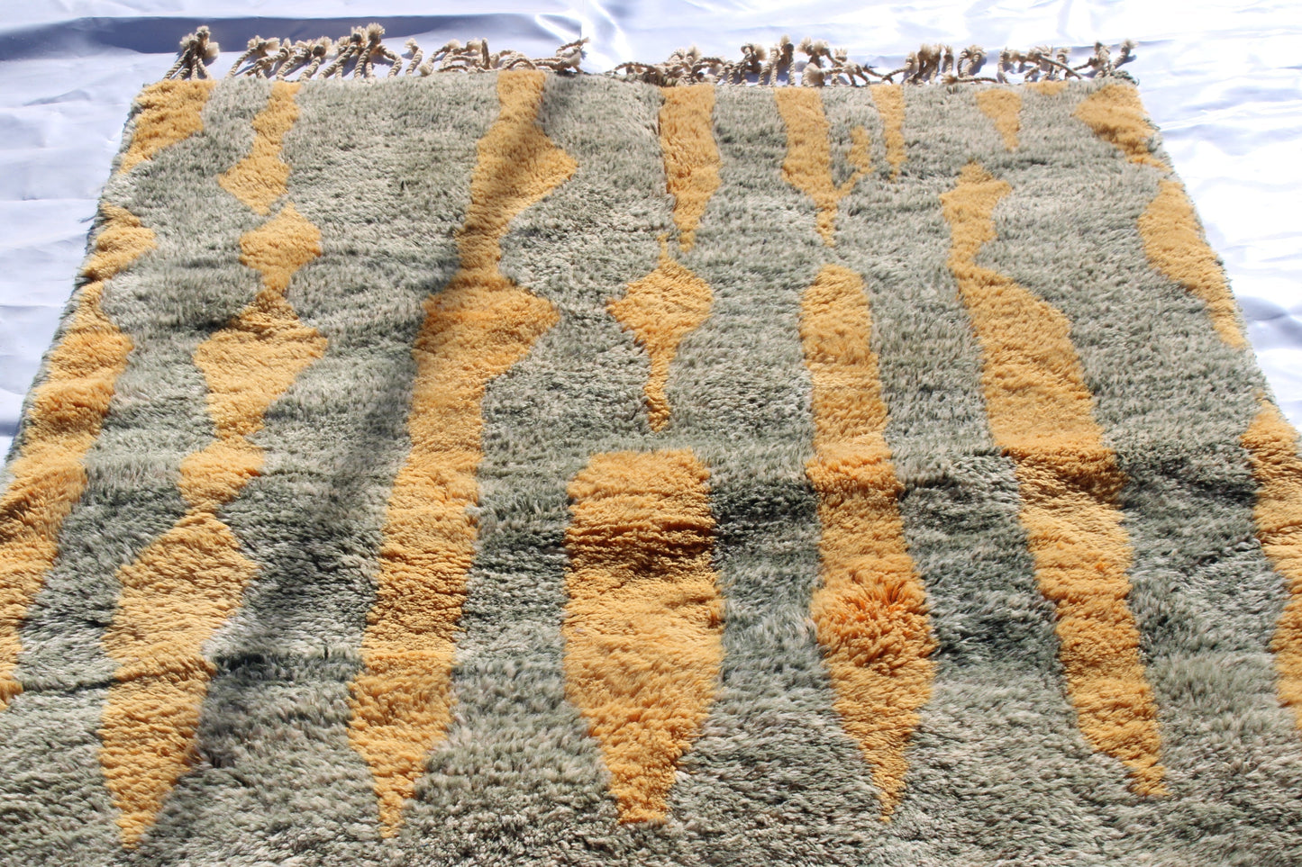 Beni Ourain rugs originate from the Atlas Mountains of Morocco and are characterized by their distinctive, neutral-toned, and geometric designs. These handwoven rugs often feature a plush pile and are made by the Berber tribes, size is 230x155 cm