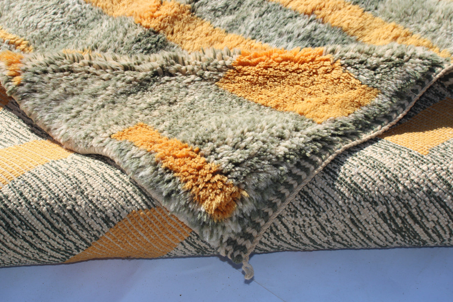 Beni Ourain rugs originate from the Atlas Mountains of Morocco and are characterized by their distinctive, neutral-toned, and geometric designs. These handwoven rugs often feature a plush pile and are made by the Berber tribes, size is 230x155 cm