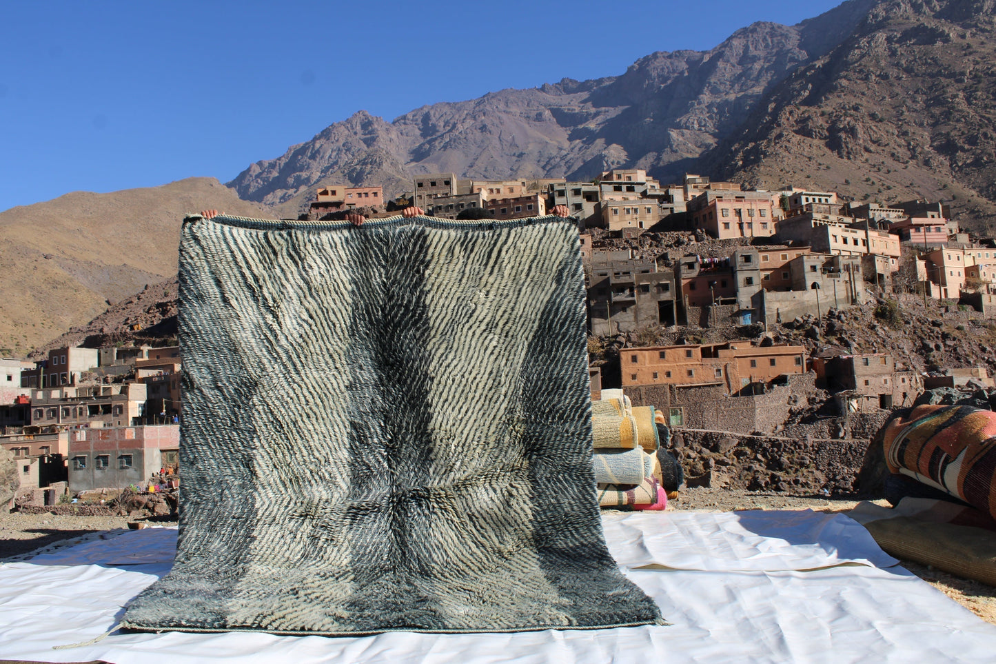 Beni Ourain rugs originate from the Atlas Mountains of Morocco and are characterized by their distinctive, neutral-toned, and geometric designs. These handwoven rugs often feature a plush pile and are made by the Berber tribes, size is 254x190 cm