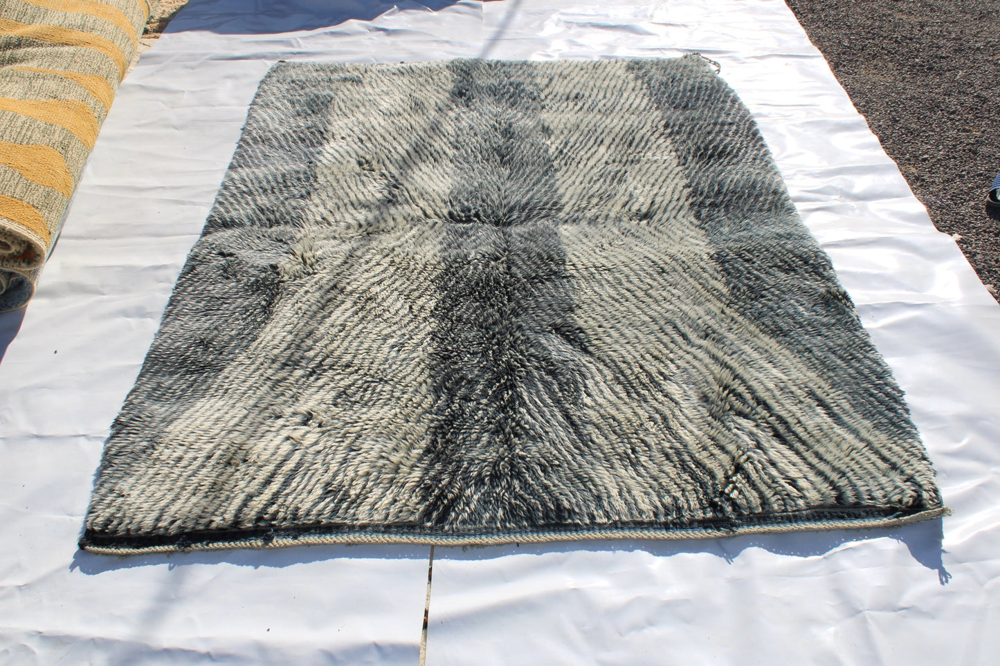 Beni Ourain rugs originate from the Atlas Mountains of Morocco and are characterized by their distinctive, neutral-toned, and geometric designs. These handwoven rugs often feature a plush pile and are made by the Berber tribes, size is 254x190 cm