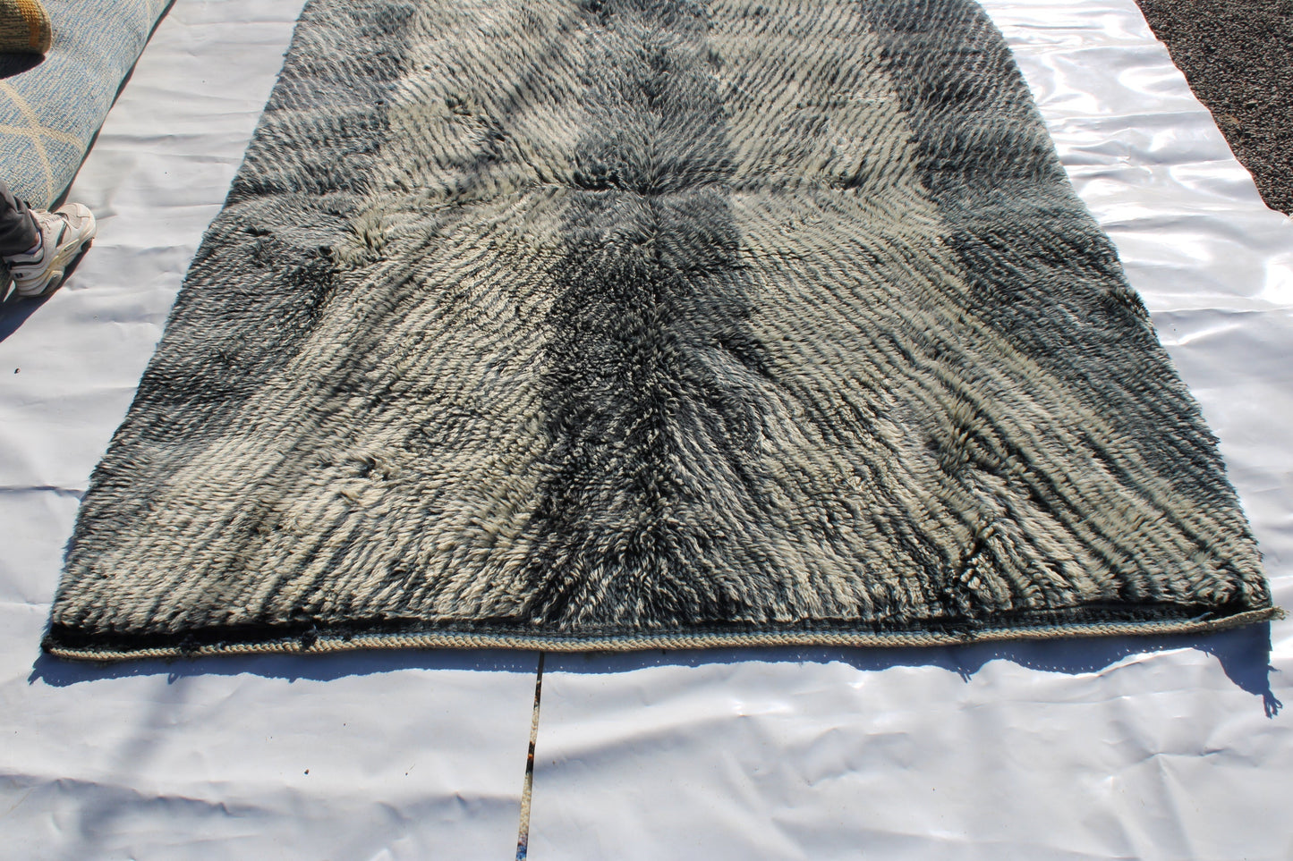 Beni Ourain rugs originate from the Atlas Mountains of Morocco and are characterized by their distinctive, neutral-toned, and geometric designs. These handwoven rugs often feature a plush pile and are made by the Berber tribes, size is 254x190 cm