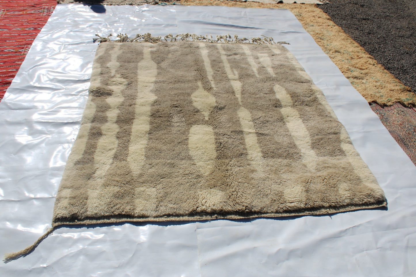 Beni Ourain rugs originate from the Atlas Mountains of Morocco and are characterized by their distinctive, neutral-toned, and geometric designs. These handwoven rugs often feature a plush pile and are made by the Berber tribes, size is 280x177 cm