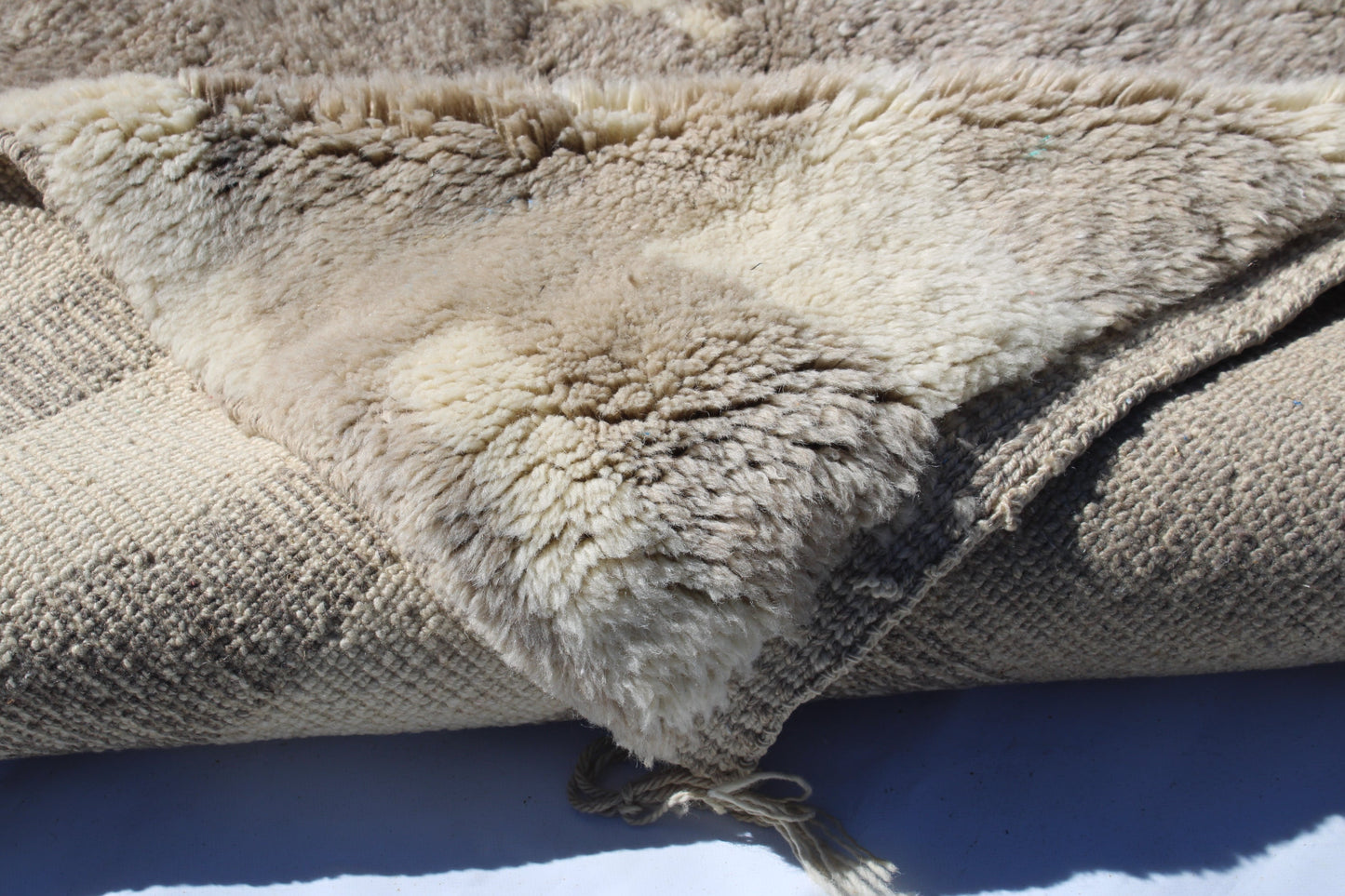 Beni Ourain rugs originate from the Atlas Mountains of Morocco and are characterized by their distinctive, neutral-toned, and geometric designs. These handwoven rugs often feature a plush pile and are made by the Berber tribes, size is 280x177 cm