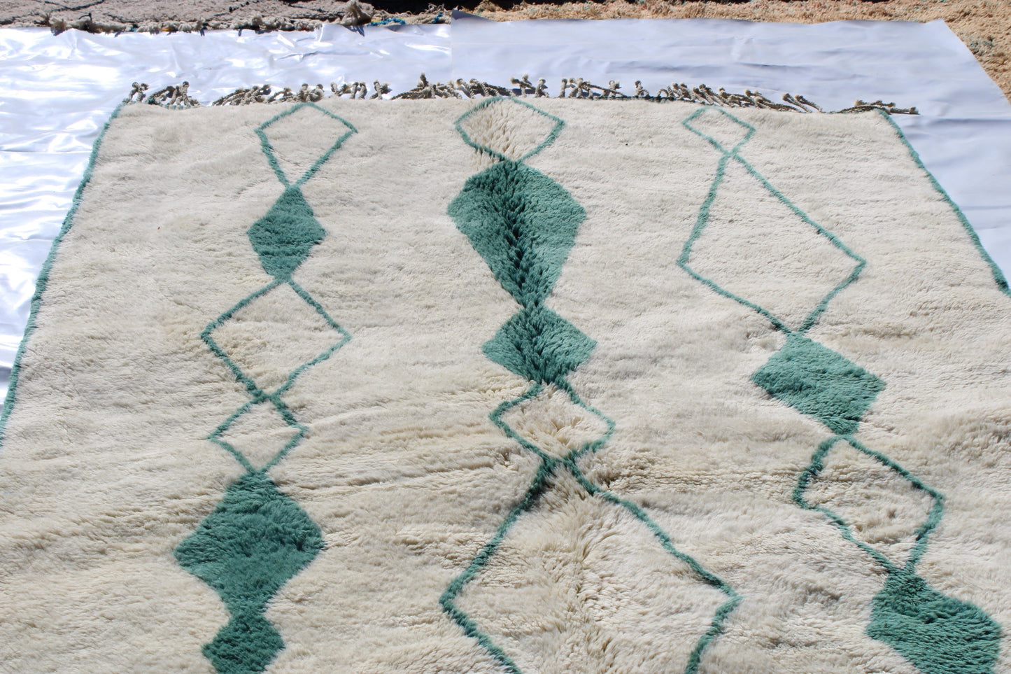 Beni Ourain rugs originate from the Atlas Mountains of Morocco and are characterized by their distinctive, neutral-toned, and geometric designs. These handwoven rugs often feature a plush pile and are made by the Berber tribes, size is 280x177 cm