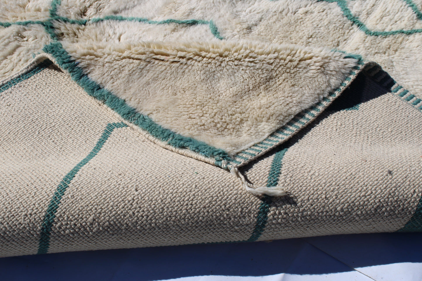 Beni Ourain rugs originate from the Atlas Mountains of Morocco and are characterized by their distinctive, neutral-toned, and geometric designs. These handwoven rugs often feature a plush pile and are made by the Berber tribes, size is 280x177 cm