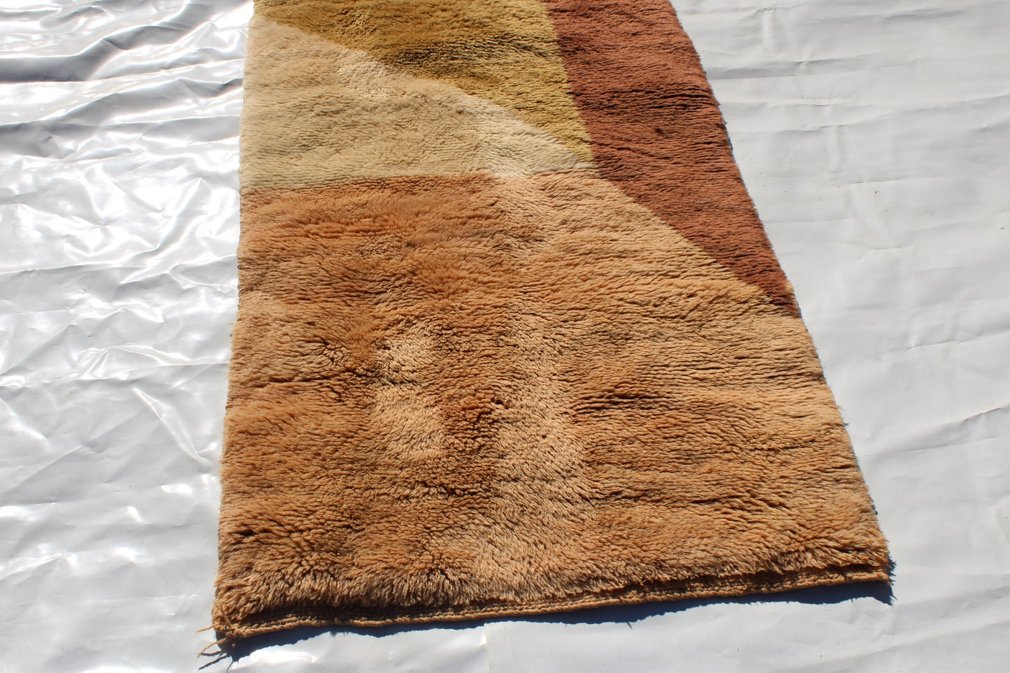 Beni Ourain rugs originate from the Atlas Mountains of Morocco and are characterized by their distinctive, neutral-toned, and geometric designs. These handwoven rugs often feature a plush pile and are made by the Berber tribes, size is 280x177 cm