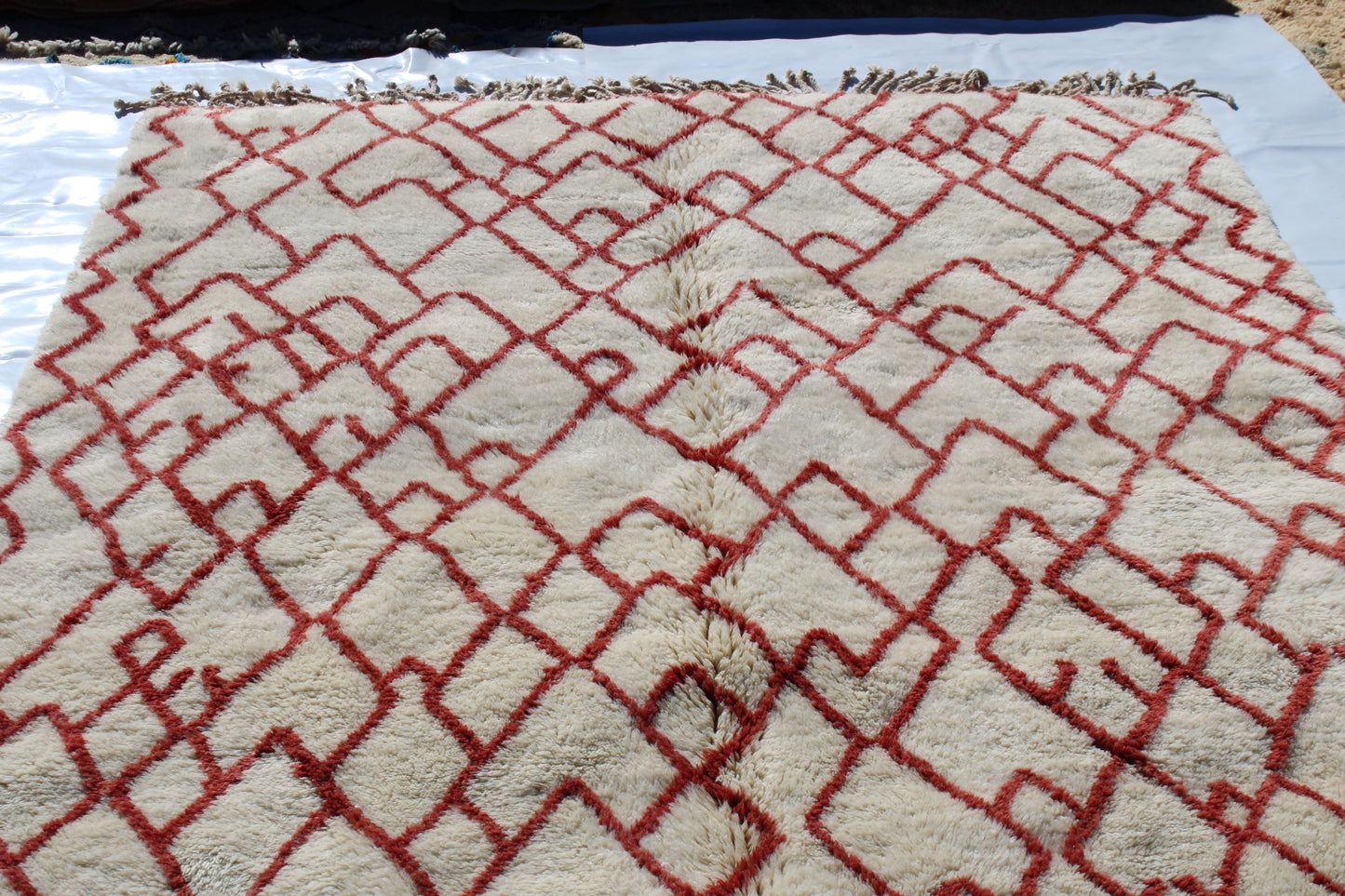 Beni Ourain rugs originate from the Atlas Mountains of Morocco and are characterized by their distinctive, neutral-toned, and geometric designs. These handwoven rugs often feature a plush pile and are made by the Berber tribes, size is 280x177 cm