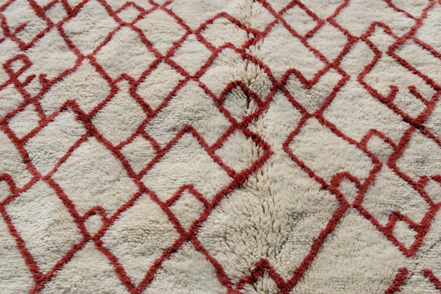 Beni Ourain rugs originate from the Atlas Mountains of Morocco and are characterized by their distinctive, neutral-toned, and geometric designs. These handwoven rugs often feature a plush pile and are made by the Berber tribes, size is 280x177 cm