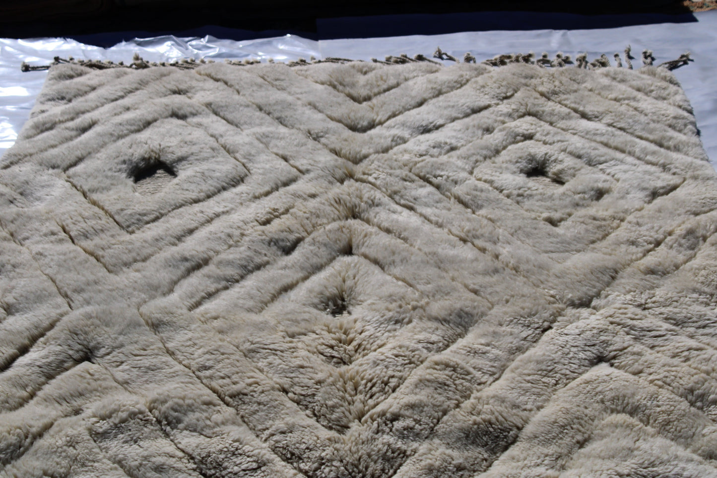 Beni Ourain rugs originate from the Atlas Mountains of Morocco and are characterized by their distinctive, neutral-toned, and geometric designs. These handwoven rugs often feature a plush pile and are made by the Berber tribes, size is 280x177 cm