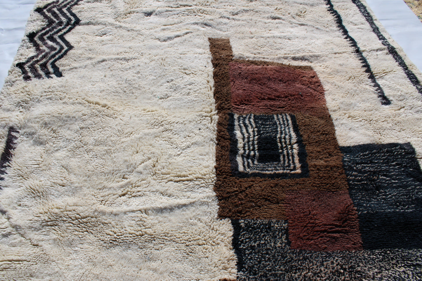 Beni Ourain rugs originate from the Atlas Mountains of Morocco and are characterized by their distinctive, neutral-toned, and geometric designs. These handwoven rugs often feature a plush pile and are made by the Berber tribes, size is 280x177 cm