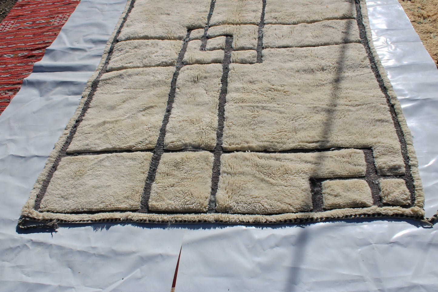 Beni Ourain rugs originate from the Atlas Mountains of Morocco and are characterized by their distinctive, neutral-toned, and geometric designs. These handwoven rugs often feature a plush pile and are made by the Berber tribes, size is 280x177 cm