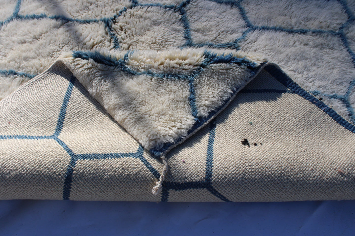 Beni Ourain rugs originate from the Atlas Mountains of Morocco and are characterized by their distinctive, neutral-toned, and geometric designs. These handwoven rugs often feature a plush pile and are made by the Berber tribes, size is 280x177 cm