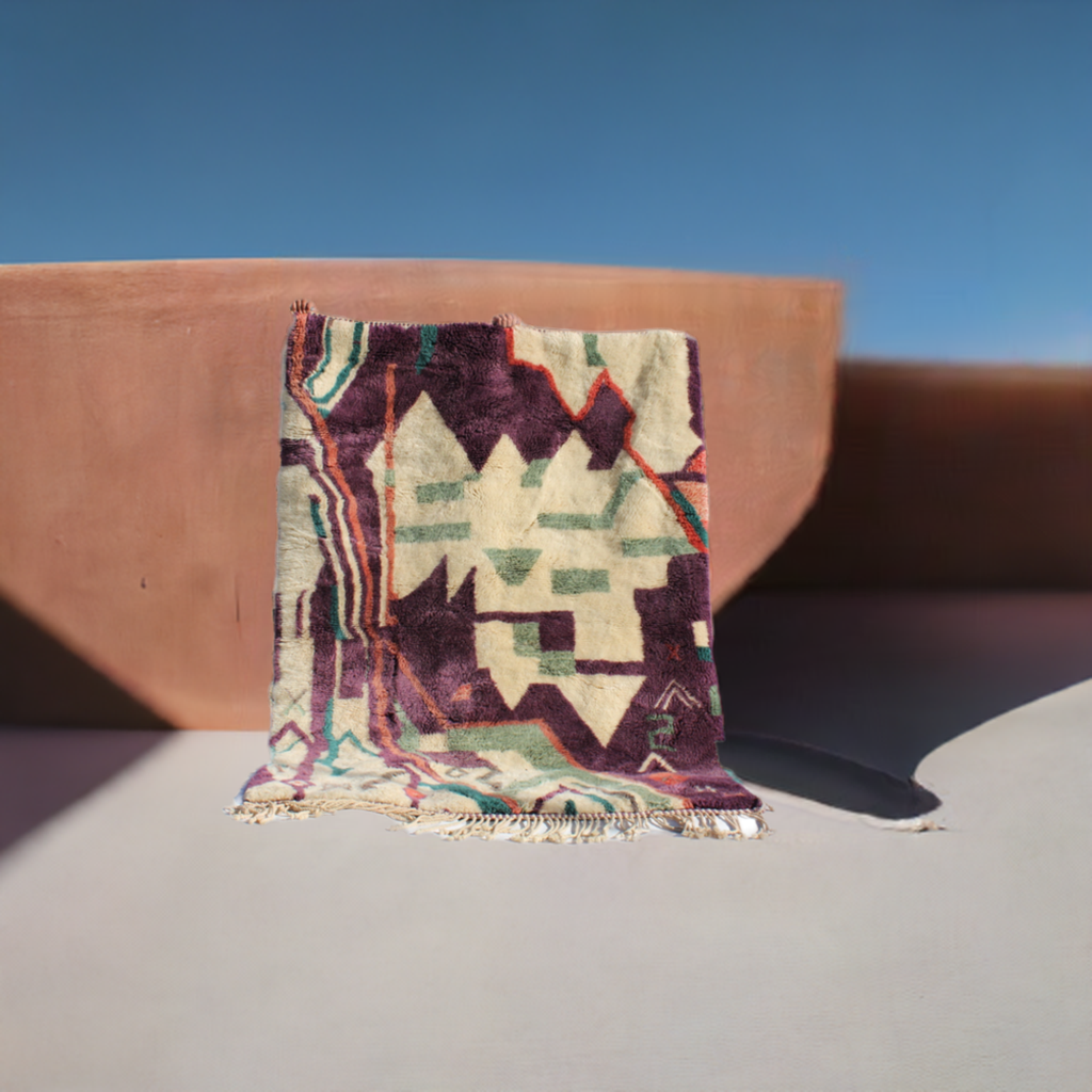 Beni Ourain rugs originate from the Atlas Mountains of Morocco and are characterized by their distinctive, neutral-toned, and geometric designs. These handwoven rugs often feature a plush pile and are made by the Berber tribes, size is 224x160 cm