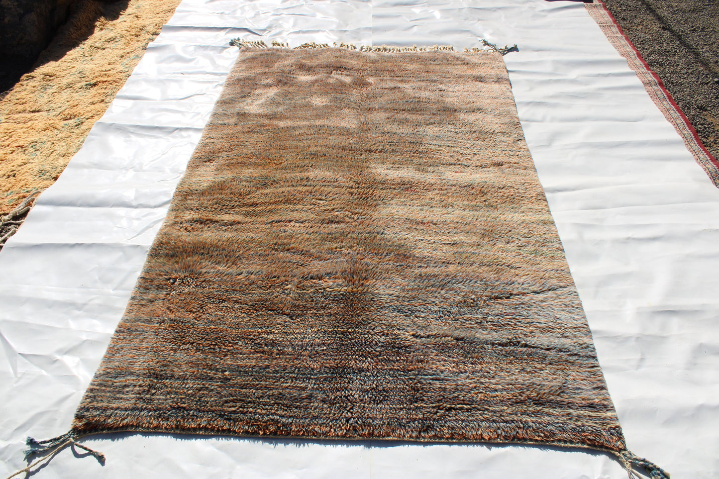 Beni Ourain rugs originate from the Atlas Mountains of Morocco and are characterized by their distinctive, neutral-toned, and geometric designs. These handwoven rugs often feature a plush pile and are made by the Berber tribes,  size is 250x155 cm